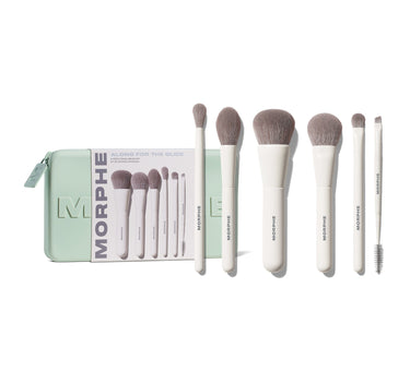 Morphe Along For The Glide 6-Piece Travel Brush Set: mint zip case reading "MORPHE ALONG FOR THE GLIDE 6-PIECE TRAVEL BRUSH SET KIT DE VOYAGE 6 PINCEAUX" displayed alongside six white-handled taupe-bristled Morphe brushes and a spoolie. | Along for the Glide 6-Piece Travel Brush Set