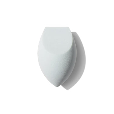 Morphe One Done Multifunctional Makeup Sponge, a white dual-sided flat-edge and rounded porous blending sponge on a white background. | One & Done Multifunctional Makeup Sponge