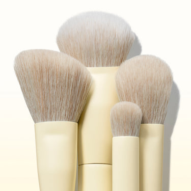 Close-up of the Morphe Buttery Blends 4 Piece Face Brush Set showing four soft, fluffy brushes with cream-yellow handles fanned together.