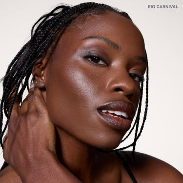 {Rio Carnival} model wearing Cheek Thrills Bronze Tone Duos in shade RIO CARNIVAL, with bronzed skin and a warm sculpted finish.