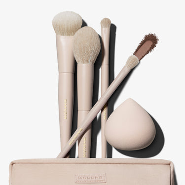Morphe Iced Oat Latte Custom Blends 5-Piece Brush Set fanned out of beige makeup bag with eyeshadow swatch and beauty sponge