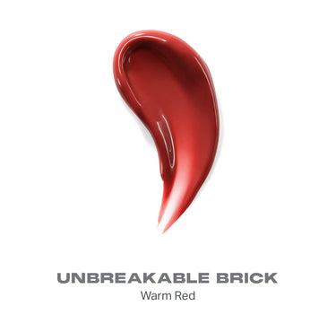{Unbreakable Brick} Dripglass Glazed High Shine Lip Gloss swatch in UNBREAKABLE BRICK – Warm Red, a rich glossy warm red shade.