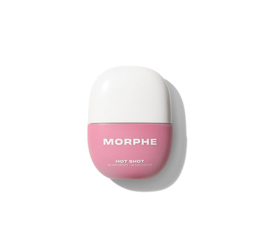 {That Girl} Closed pink jar of Morphe Hot Shot Blush Drops with white cap, labeled MORPHE / HOT SHOT / BLUSH DROPS / BLUSH LIQUIDE.
