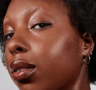 {Deep 31W} Model wearing Lightform Extended Hydration Foundation in Deep 31W showing luminous, hydrated finish on deep skin.