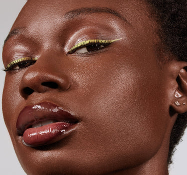{Deep 32N} Model wearing Morphe Lightform Extended Hydration Foundation with luminous dewy finish, chartreuse liner, and glossy berry lip.