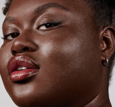 {Deep 36N} Close-up model shot wearing Lightform Extended Hydration Foundation in Deep 36N, showcasing a luminous, dewy, hydrated complexion finish.