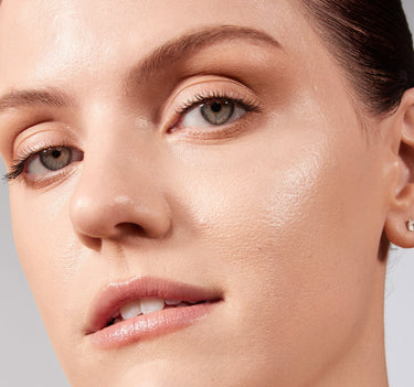 {Light 02N} Model close-up wearing Lightform Extended Hydration Foundation in Light 02N, showing a dewy, luminous, hydrated skin finish.