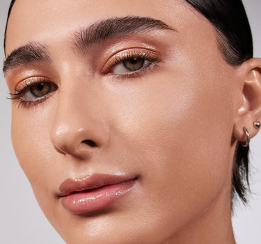 {Medium 10C} Model wearing Lightform Extended Hydration Foundation in Medium 10C, showing a luminous, hydrated finish on light-medium skin.