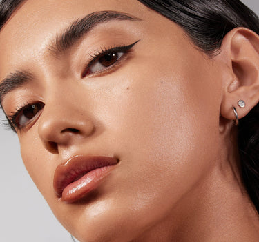 {Medium 13N} Close-up of model wearing Lightform Extended Hydration Foundation in Medium 13N with glowing, dewy skin and luminous finish.