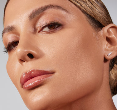 {Medium 14W} Close-up of model wearing Lightform Extended Hydration Foundation in Medium 14W, showcasing a dewy, luminous finish on medium warm-toned skin.