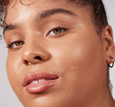 {Tan 15N} Close-up of model wearing Lightform Extended Hydration Foundation in Tan 15N, showing luminous, dewy skin finish.