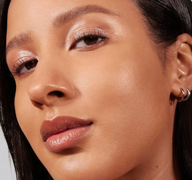 {Tan 16N} Model wearing Lightform Extended Hydration Foundation in Tan 16N, showcasing a dewy, glowing, hydrated skin finish.