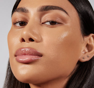 {Tan 17W} Close-up of model wearing Lightform Extended Hydration Foundation in Tan 17W, showing a luminous, dewy finish on medium-tan skin.
