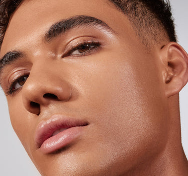 {Tan 21C} Close-up of model wearing Lightform Extended Hydration Foundation in shade Tan 21C, showcasing a luminous, dewy finish on warm medium-deep skin.
