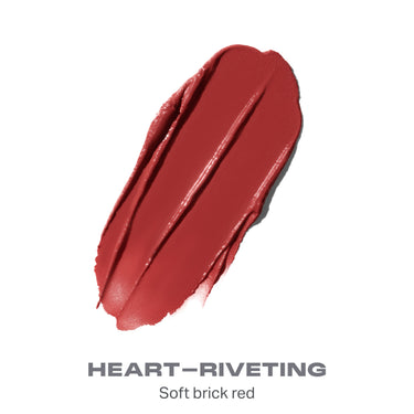 {Heart-Riveting} Liplock Glossy Lipstick shade swatch in soft brick red with text "HEART–RIVETING Soft brick red."