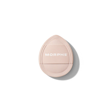 Morphe Cloud Cushion Seamless Puff applicator in pale pink with woven texture, back view showing white MORPHE wordmark. | Cloud Cushion Seamless Puff