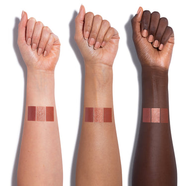 Cheek Thrills Multi Finish Face Trio Yacht Day arm swatches showing three shades — matte rose, champagne shimmer, and warm bronze — across light, medium, and deep skin tones.