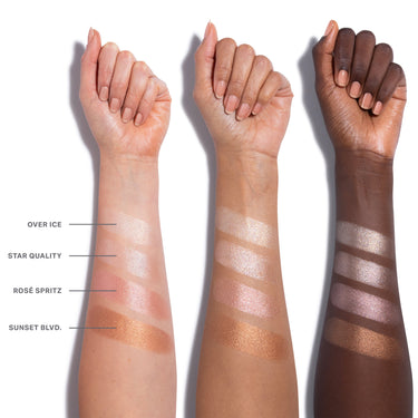 Dreamlight Gelée Highlighter Stick arm swatches across three skin tones showing shades OVER ICE, STAR QUALITY, ROSÉ SPRITZ, and SUNSET BLVD.