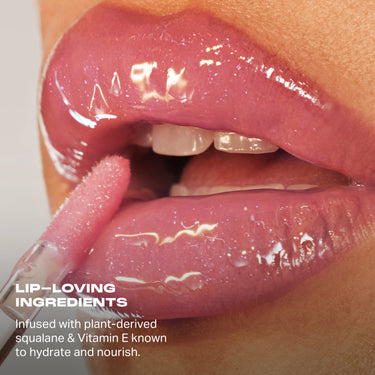 Dripglass Glazed High Shine Lip Gloss applied to lips with applicator; text reads "LIP-LOVING INGREDIENTS — Infused with plant-derived squalane & Vitamin E known to hydrate and nourish."