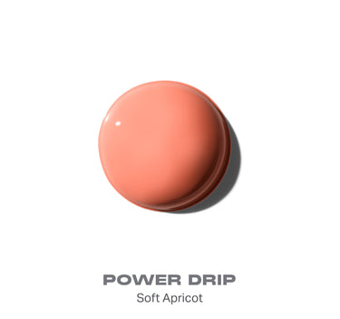 {Power Drip} Morphe Hot Shot Blush Drops smear swatch in shade Power Drip — Soft Apricot, a glossy peachy-coral drop on white. | Hot Shot Blush Drops | Secondary image