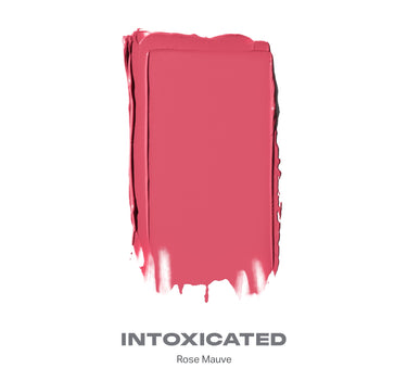 {Intoxicated (rose mauve)} Huephoric Rush 3-In-1 Silk Blush swatch labeled INTOXICATED, Rose Mauve, showing creamy rose mauve blush texture.