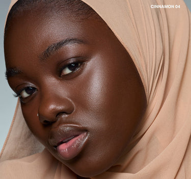 {Cinnamon 04} Model wearing Wakeup Artist Under Eye Correcting Concealer in CINNAMON 04, showcasing a luminous, corrected under-eye finish.