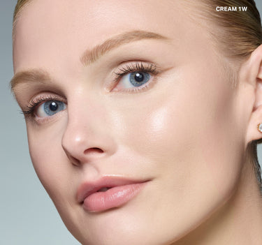 {Cream 1w} Model wearing Wakeup Artist Under Eye Correcting Concealer in CREAM 1W, showing seamless coverage under eyes on fair skin.