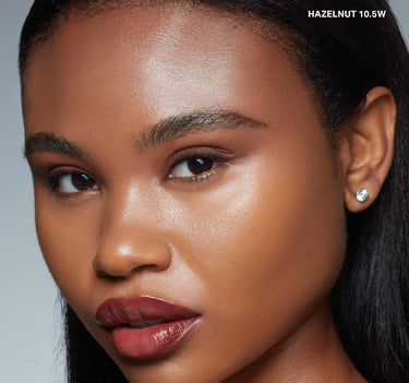 {Hazelnut 10.5w} Model wearing Wakeup Artist Under Eye Correcting Concealer in shade HAZELNUT 10.5W with flawless warm-toned under-eye coverage.