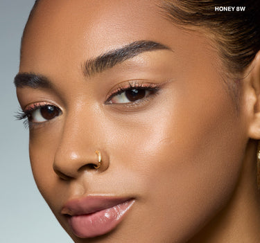 {Honey 8w} Model wearing Wakeup Artist Under Eye Correcting Concealer in shade HONEY 8W blended seamlessly under eyes.