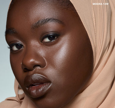 {Mocha 13w} Model wearing Wakeup Artist Under Eye Correcting Concealer in shade MOCHA 13W, shown on deep skin tone with a neutral hijab.