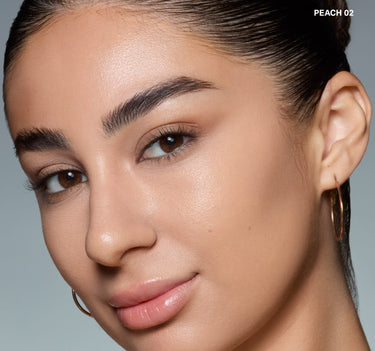 {Peach 02} Model wearing Morphe Wakeup Artist Under Eye Correcting Concealer in PEACH 02 blended under eyes for a bright, corrected finish.