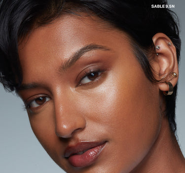 {Sable 9.5n} Wakeup Artist Under Eye Correcting Concealer in SABLE 9.5N on model, warm peachy-brown shade blended seamlessly under the eyes.