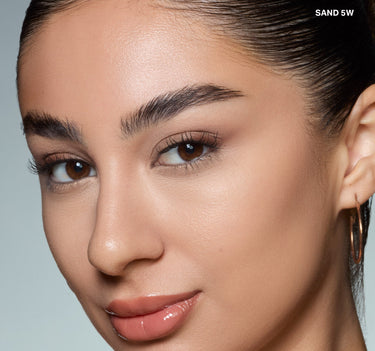 {Sand 5w} Model wearing Wakeup Artist Under Eye Correcting Concealer in SAND 5W, showing seamlessly blended, brightened under-eye coverage.