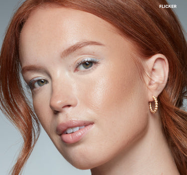 {Flicker} Model wearing Sudden Heat Creamy Bronzer Stick in shade FLICKER, showing a warm, dewy bronze glow on cheeks and skin.