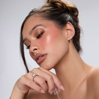 Model wearing Morphe Cheek Thrills Multi-Finish Face Trio Yacht Day with warm bronzed glow, rosy blush, and glossy lips.