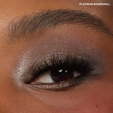 {Platinum Bombshell} Dazzling Metallics Eyeshadow Trio close-up eye look with shimmery platinum and smoky shadow, labeled PLATINUM BOMBSHELL.