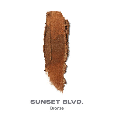 {Sunset Blvd.} Dreamlight Gelee Highlighter Stick shade swatch in warm bronze metallic labeled SUNSET BLVD. Bronze.