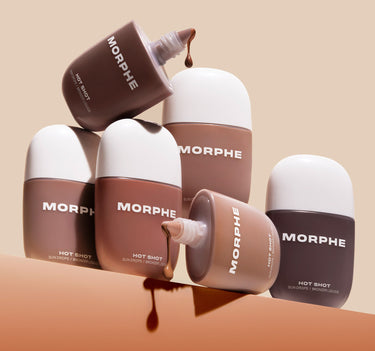{Money Honey} Group of Morphe Hot Shot Sun Drops / Bronzer Liquide bottles in varied bronzer shades stacked with droppers open and liquid drips spilling out.